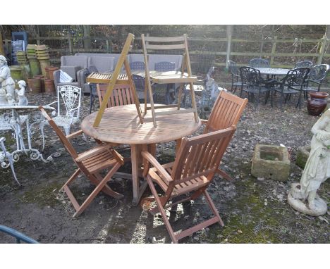 A CIRCULAR TEAK DROP LEAF GARDEN TABLE, diameter 124cm x height 75cm, together with four matching folding armchairs and two o