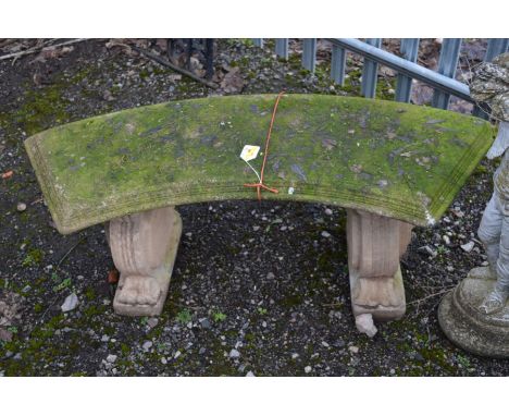 A COMPOSITE ARCHED GARDEN BENCH, on a twin scrolled base, width 120cm x height 48cm