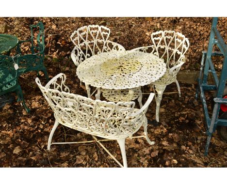 A WHITE GROUND CIRCULAR ALUMINIUM GARDEN TABLE, with foliate decoration, diameter 80cm x height 62cm, a matching two seater b