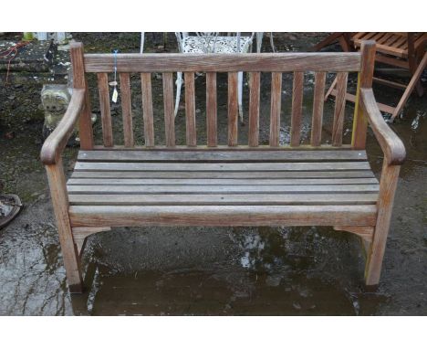 A TEAK SLATTED GARDEN BENCH, width 123cm togehter with a bespoke garden table made from horse shoes (2)