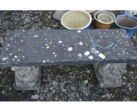 A PAIR OF COMPOSITE GARDEN BENCHES, on a separate lion bases, (one top broken to a single bench) (2)