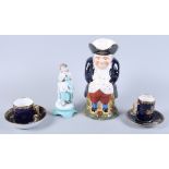 Two Vienna porcelain coffee cans and saucers decorated figures on a blue ground with gilt