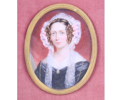 An early Victorian portrait miniature of an unknown woman with side curls and lace lappets, 3" x 2 1/4", in oval mount and gi
