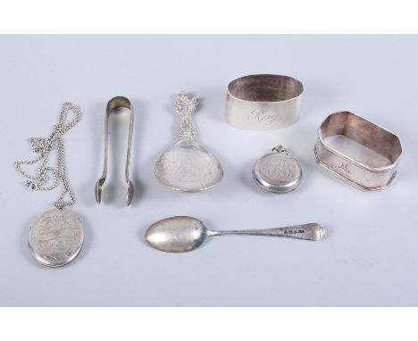 A Continental silver caddy spoon, the handle cast with the Virgin Mary, a silver napkin ring, a plated napkin ring, an engrav