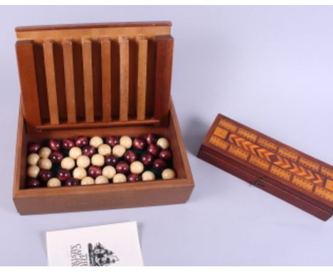 A walnut and satinwood banded boxed game, "The Captain's Mistress", and a mahogany and inlaid cribbage box 