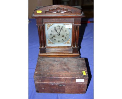 A wooden box containing approx twenty-two lead ingots, most marked "Lyman", together with an oak cased bracket clock with sil