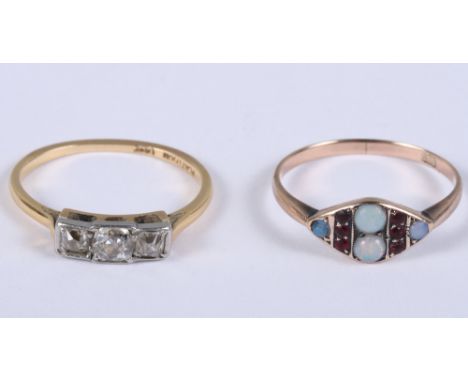 A German 8ct gold, opal and garnet dress ring, size O, 1.4g, and a 18ct gold, platinum and diamond three-stone dress ring, si