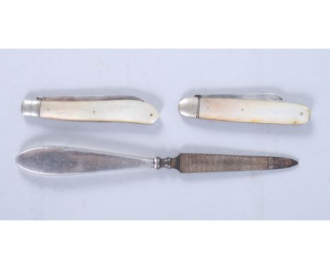 Two folding fruit knives with silver blades and mother-of-pearl handles and a silver-handled nail file 