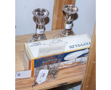 A pair of late Victorian silver plate telescopic candlesticks, a boxed Schylling airship and a chrome plated dog corkscrew 