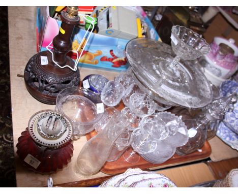 A Bohemian ruby flashed etched glass vase and other glassware, including a cranberry glass reservoir, and a carved African ha