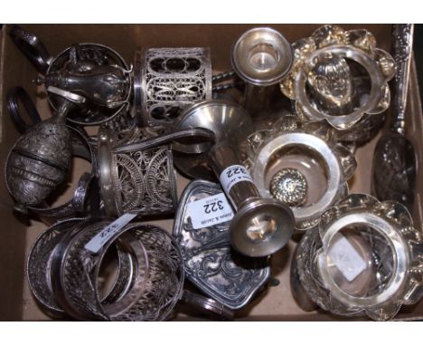 A set of three cut glass tea light holders with silver mounts, a pair of silver pepper shakers, a silver tablespoon, a silver