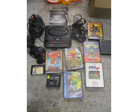 A Sega Mega drive II game console stick and handset, with various games 