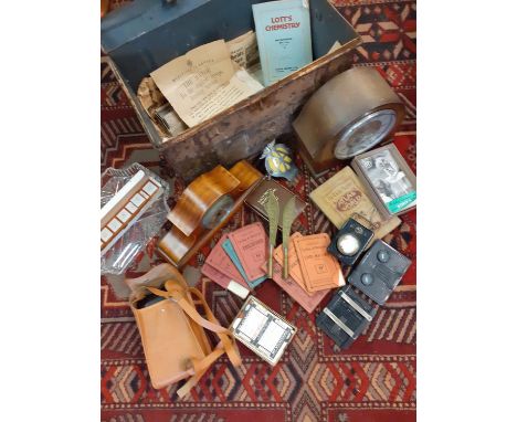 A domed vintage trunk containing mixed items to include a small 1950s bicycle lamp, vintage maps, an AA car badge, a vintage 