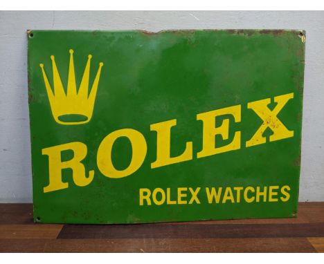 A reproduction enamel advertising sign Rolex, in yellow on a green ground, 36cm x 51cm