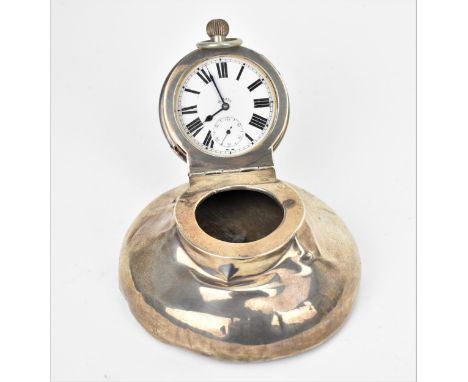 An Edwardian silver capstan inkwell with Goliath pocket watch inset to the lid, with wooden base, 13 cm diameter, A/F 