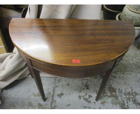 A George III mahogany card table on square tapering legs 