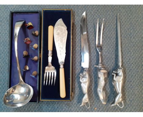A set of eight enamelled place setting holders in the form of young ladies together with a modern carving set with handles in