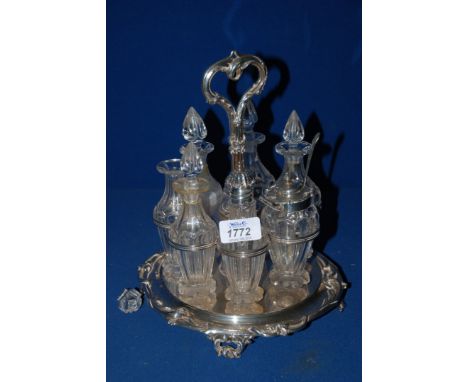 A seven piece glass Cruet on quality plated stand, some bottles a/f, two with silver tops