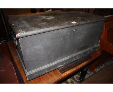 A 19th c. stained Pine Travel Trunk having one piece moulded edge top with original lock and iron strap hinges, opening to re