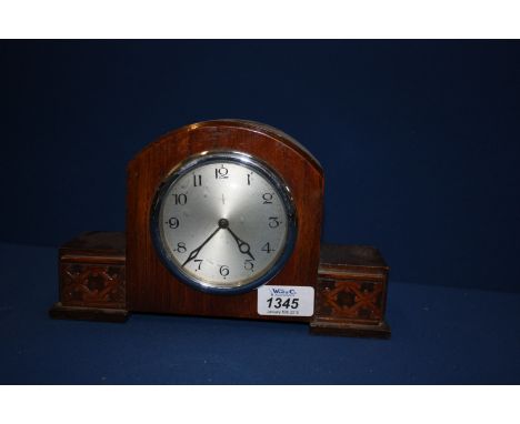 A mantle Clock with carved detail -  In working order