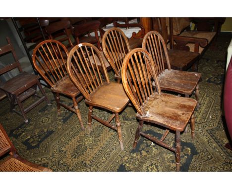 A set of five stick back Elm seated, Oak framed country Dining Chairs, standing on turned legs with stretchers