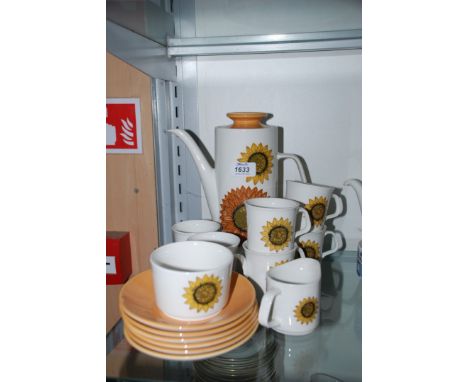 A Meakin Coffee set in Sunflower design comprising sugar bowl, jug, coffee pot, six cups and saucers