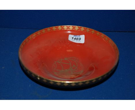 A Royal Worcester Crown ware bowl in matt black with a rust lustre interior and decorated with a galleon, 8'' diameter.