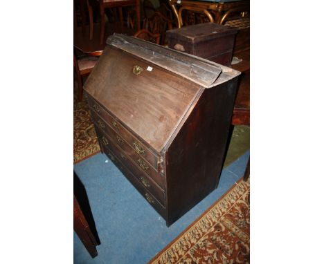 An early Georgian Mahogany Bureau, plain top, the well figured fall opening to reveal two upper, slender wide drawers, over t