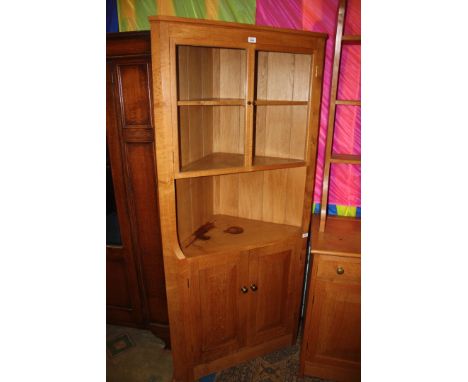 A superb quality bespoke light Oak floor standing Corner Cabinet, having lightly moulded cornice, upper pair of single pane g