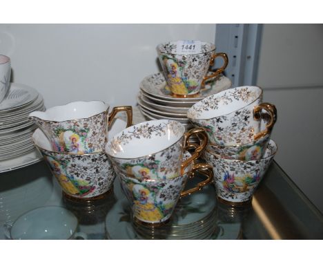 A pretty Teaset in 'Garden House' design decorated with floral gilt design and crinoline lady standing in garden scene, and c