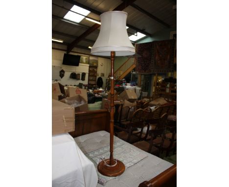 A turned wooden Standard Lamp and Shade