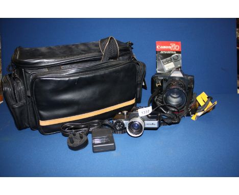 A Canon T70 Camera with 35-105mm lens and user's guide, a Minolta Camera plus black camera bag