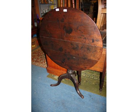 A Georgian Circular Oak Snap Top Table on Baluster Tripod Base.