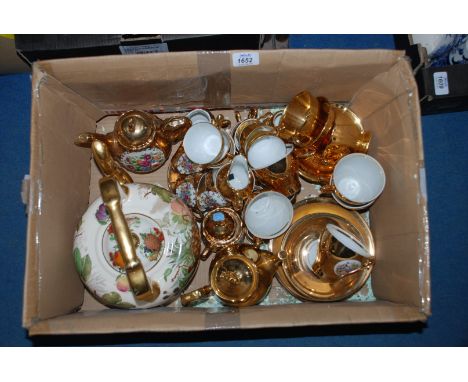 A good quantity of gold lustre china, mainly coffee ware and a large porcelain Teapot decorated with fruit.