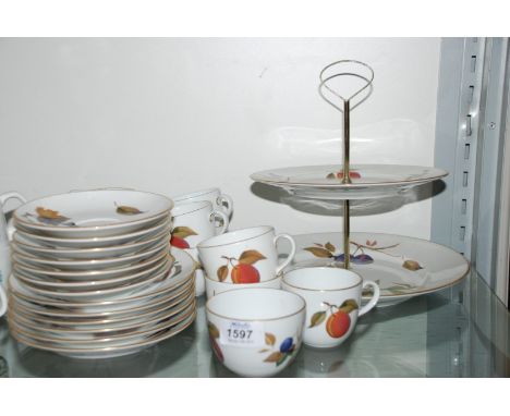 A Royal Worcester ''Evesham'' including seven cups and saucers, milk jug, sugar bowl, tea plates and two tier cake stand