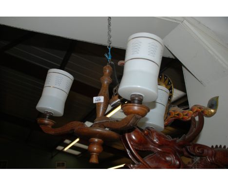 A darkwood three light electrolier with glass shades.