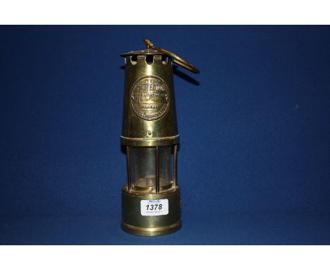 A Brass Miner's Lamp by The Protector Lamp and Lighting Co. Ltd., Eccles, Manchester.  10 1/2'' tall
