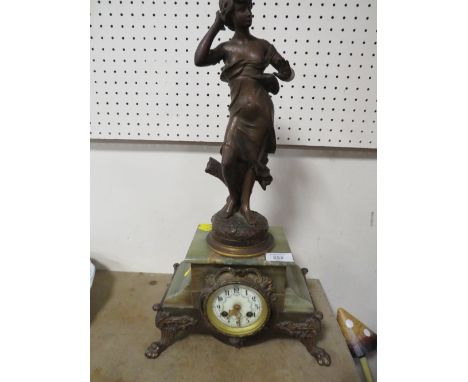 A FIGURAL CLOCK ON ONYX AND GILT METAL BASE