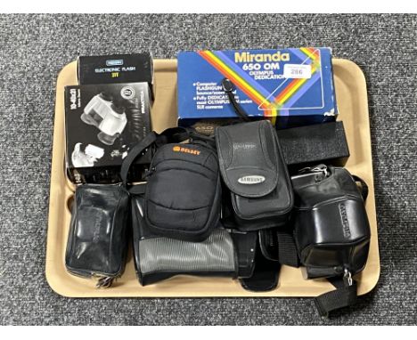A tray of assorted cameras and accessories to include Olympus OM10, Fujifilm digital camera, etc and Praktica micro zoom bino
