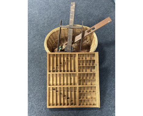 A wicker log basket, vintage spirit level, wooden artists easel and a printer's type tray 