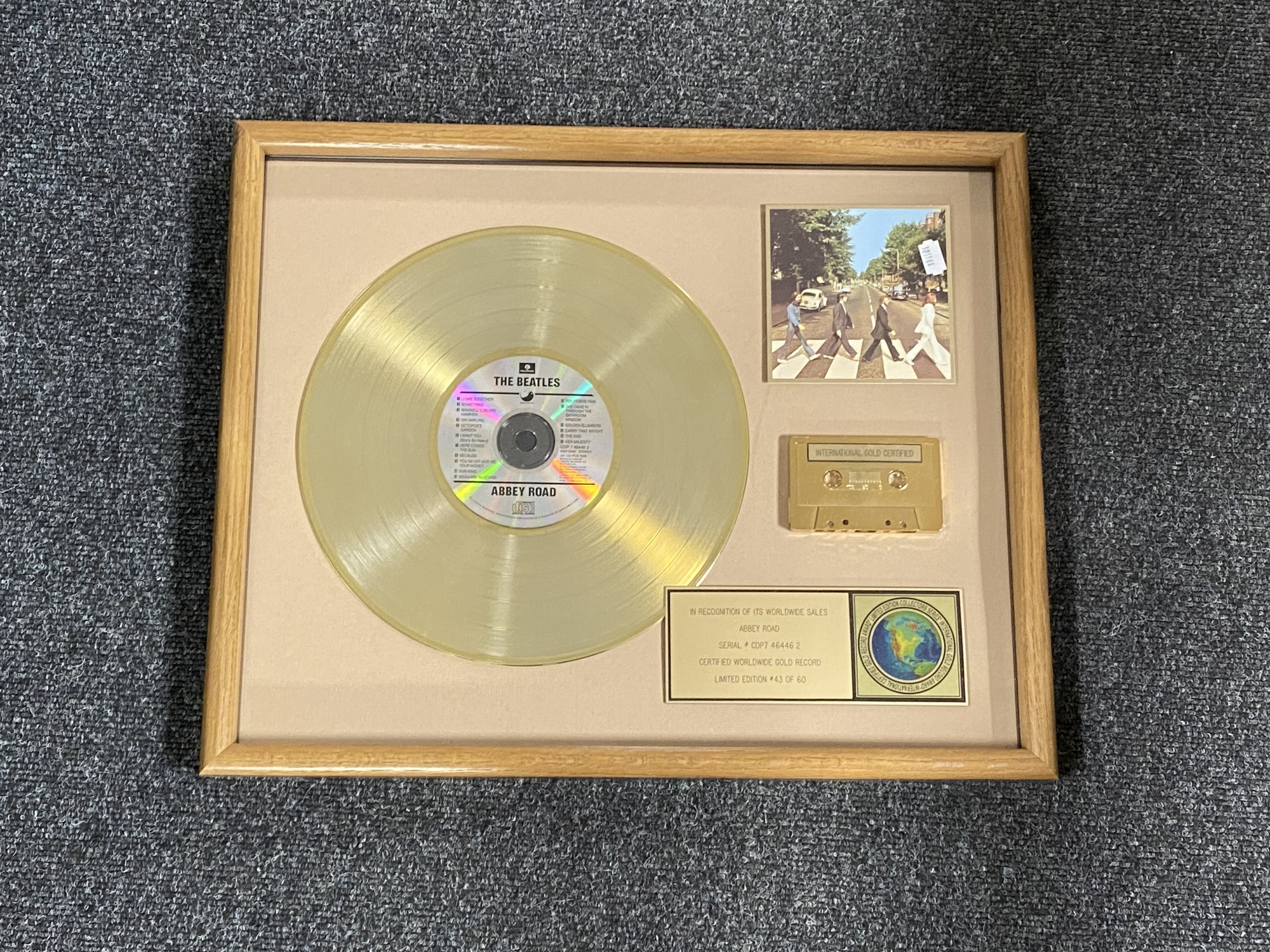 A framed The Beatles Abbey Road limited edition gold record, number 43