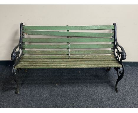 A cast iron and wooden slatted garden bench 
