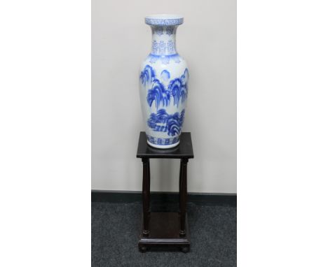 A late 20th century Chinese blue and white vase and a two tier plant stand on ball feet 