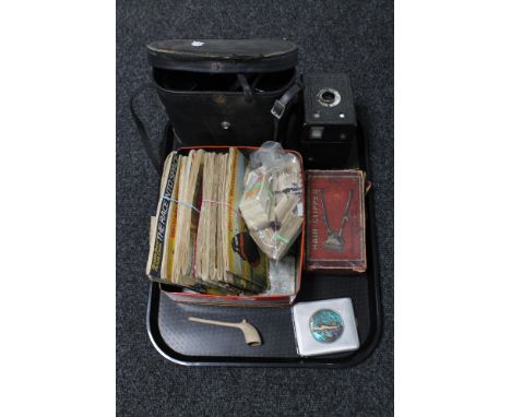 A tray of cased binoculars, tea card albums and cards, hair clippers, Brownie camera, clay pipes etc 