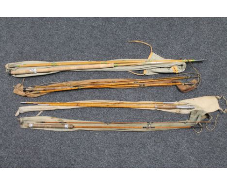 Three vintage split cane fly rods in carry bags and a two piece fly rod 