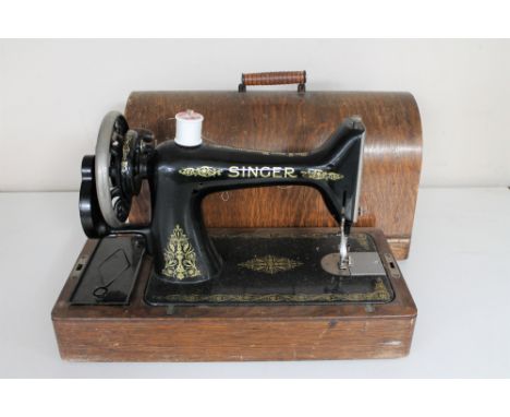 A vintage oak cased Singer hand sewing machine 