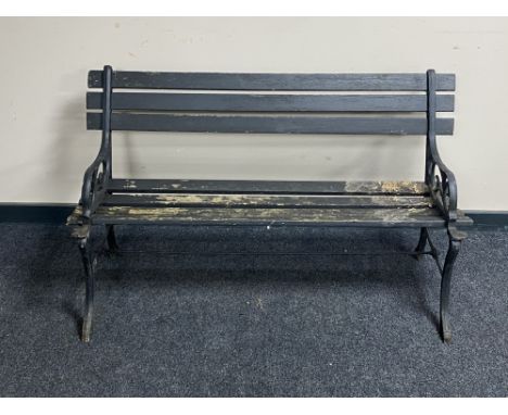 A cast iron and wooden slatted garden bench 