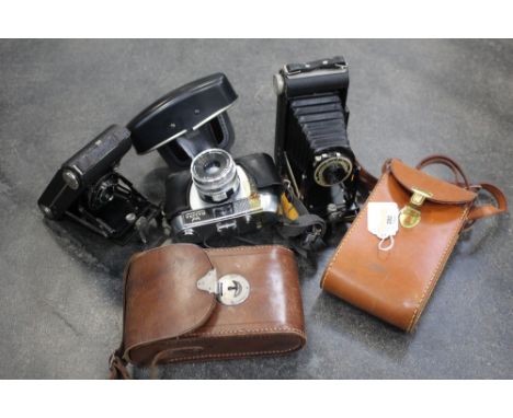 Two vintage Kodak folding cameras and leather cases and Helina 35 mm camera 