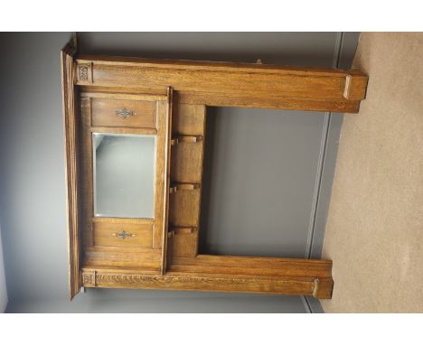 Large early 20th century inlaid oak fire surround, projecting cornice, panelled back with bevel edged centre mirror above bra