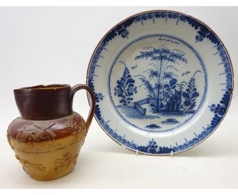 19th/ early 20th century tin glazed circular dish, decorated with a garden landscape, D34.5cm and a Victorian salt glazed Hun